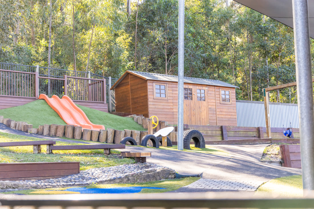 The cubby house and slides on the hill