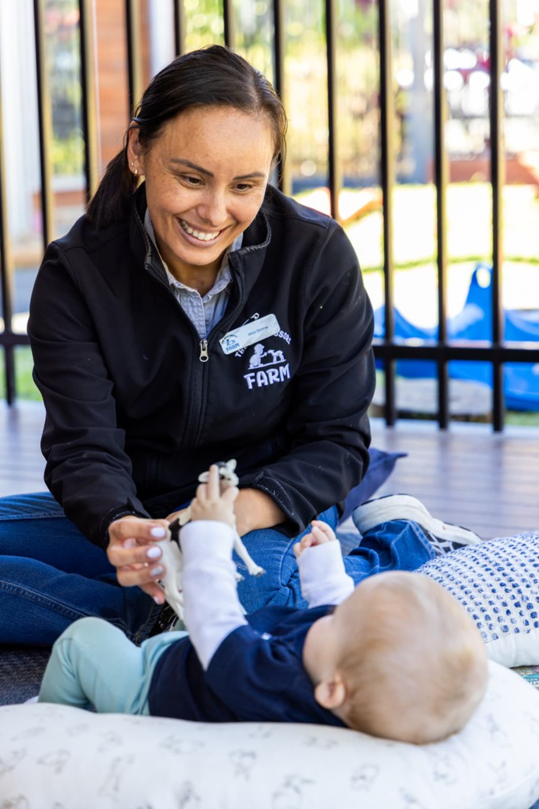An educator caring for a baby in the Nido room